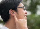 Man pointing to his hearing aid - When to see an audiologist
