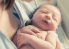 Newborn baby in mother's arms - Infant head shape