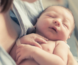 Newborn baby in mother's arms - Infant head shape