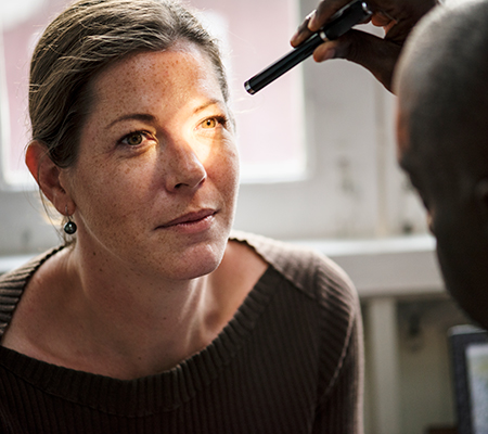 Woman getting an eye exam - Broken blood vessel in the eye