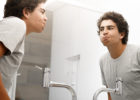 Teenage boy using mouthwash - Oil pulling trend