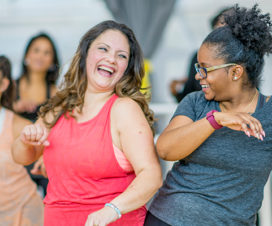 Two women dancing in Zumba - Dense breast tissue