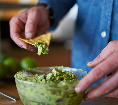 Person dipping chip in guacamole - Double dipping