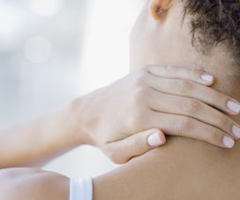 Woman rubbing her neck - Pinched nerve and neck pain
