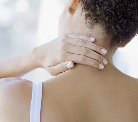 Woman rubbing her neck - Pinched nerve and neck pain