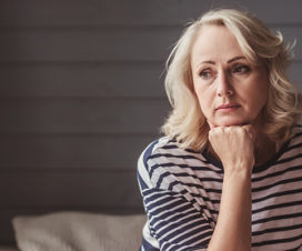 Woman on the couch looking distant - Normal worry versus anxiety