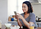 Woman on her phone in the kitchen - Can you prevent breast cancer? Chemoprevention