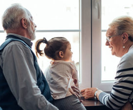 Grandparents talking to granddaughter, toddler - Legacy building and dignity therapy