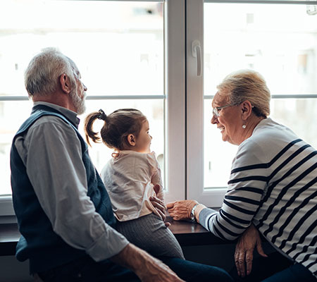 Grandparents talking to granddaughter, toddler - Legacy building and dignity therapy