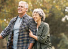 Senior couple walking in a park - Exercise for coronary heart disease
