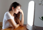 Woman sitting in front of a light - Light therapy for seasonal affective disorder