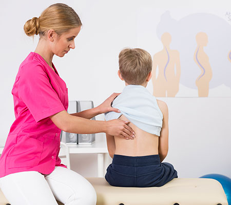Image of doctor checing young patient's back
