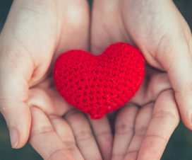 Person holding a crocheted heart - What is an enlarged heart?