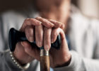 Woman holding a cane out - What is Parkinson's disease?
