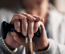 Woman holding a cane out - What is Parkinson's disease?