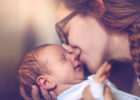 Mother kissing newborn baby - Donating breast milk