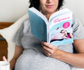 Photo of a pregnant women reading a book