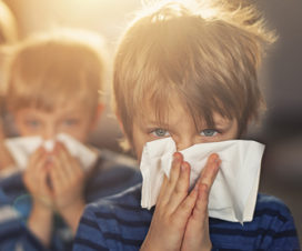 Photo of young boys blowing their nose