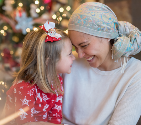 Image of mother with cancer embracing her daughter