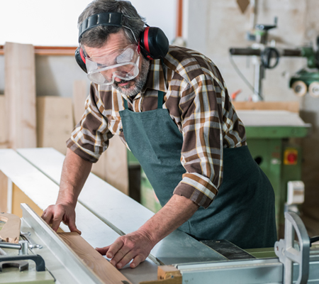 Image of man wearing hearing protection while working in shop