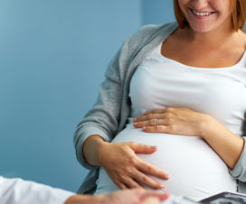 Photo of pregnant woman talking to their provider