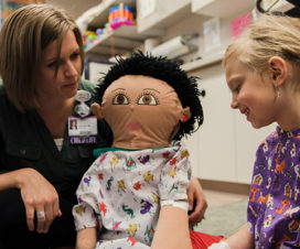 A Child Life specialist interacts with a patient.