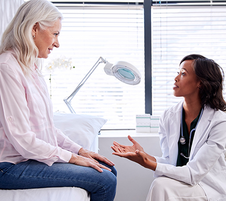 Woman and doctor discuss secondary cancer