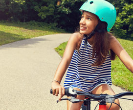 A girl rides her bike.