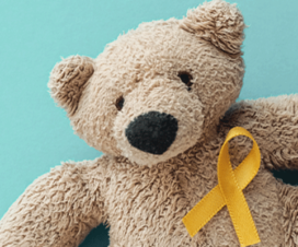 A teddy bear with a yellow ribbon.