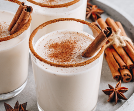 eggnog with cinnamon stick in it