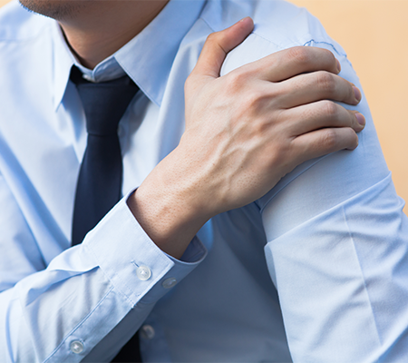 man holding shoulder after a COVID-19 vaccine