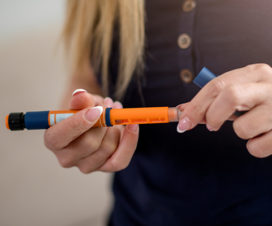 person holding an epipen