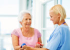 older woman with provider going through occupational therapy