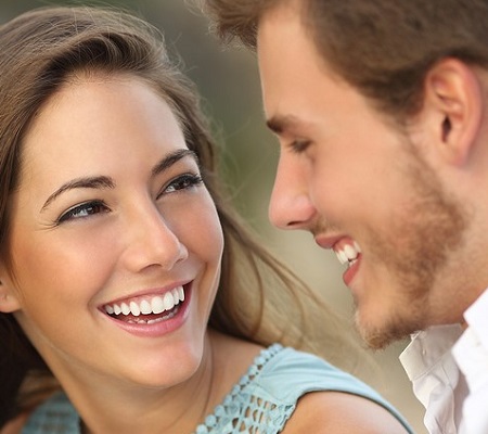 Image of young couple smiling while outside