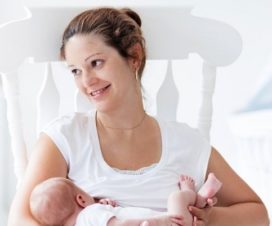 woman with urogynecology problems holding baby