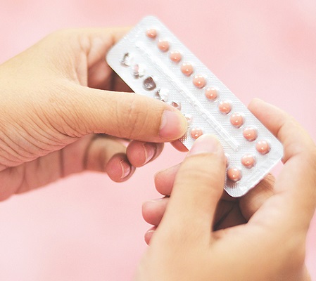 Contraception pills in hand woman holding / Birth control contraceptive means prevent pregnancy 