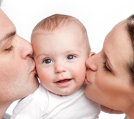 young father and mother kissing baby while receiving advice for newborn parents