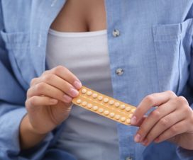 young woman with birth control pills