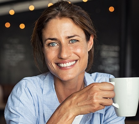 Portrait of smiling lady relaxing in a coffee shop. 