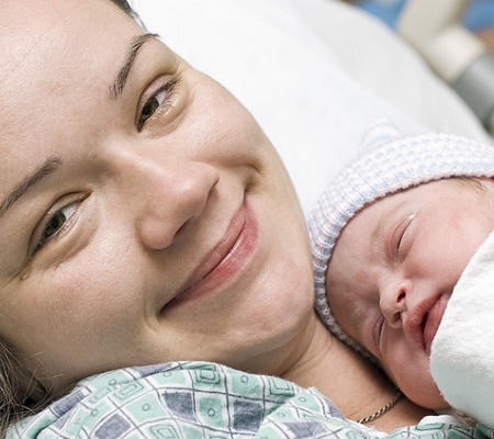 Happy mother with newborn baby in hospital - hypnobirthing