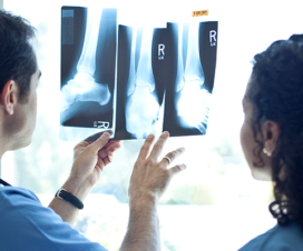 Podiatrist reviews X-rays with patient