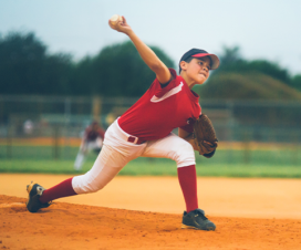 kid pitching a baseball trying to reduce pitching injuries