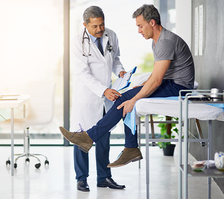 doctor examines a patient's knee to assess same-day discharge option