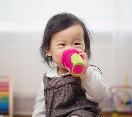 toddler with sippy cup after transitioning from bottle