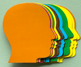 colorful cutouts of the side profiles of faces showing mental health