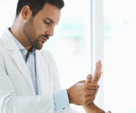 doctor checking a man's hand during an appointment