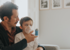 man using an inhaler on a kid