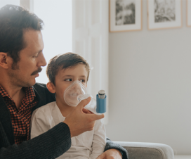 man using an inhaler on a kid