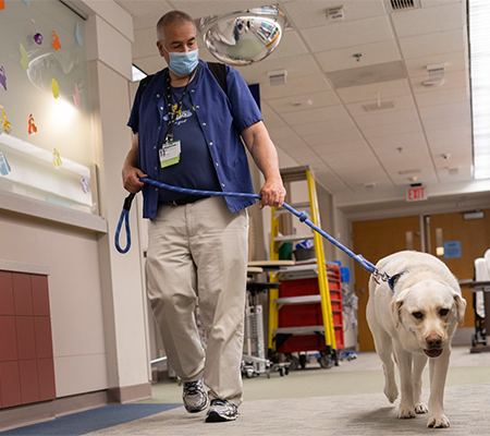 Craig Lefebvre and Finley using pet therapy at Marshfield Children's Hospital