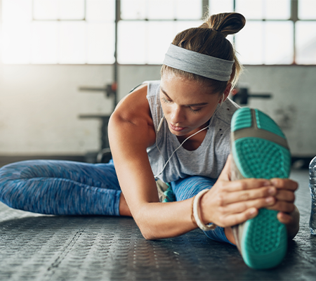 woman stretching before workout with the latest health trend